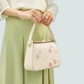 model-holding-plum-blossom-bag-both-hands-front