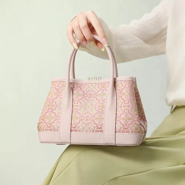 song-brocade-pink-dingsheng-crossbody-bag-model-green-dress-sitting-knee song-brocade-pink-dingsheng-crossbody-bag-model-green-dress-sitting-knee