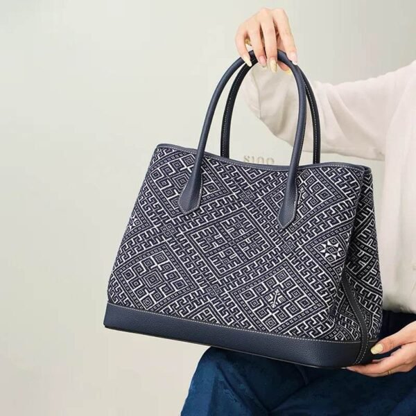 zhuang-brocade-embroidered-leather-shoulder-bag-model-sitting-knee-blue-dress zhuang-brocade-embroidered-leather-shoulder-bag-model-sitting-knee-blue-dress